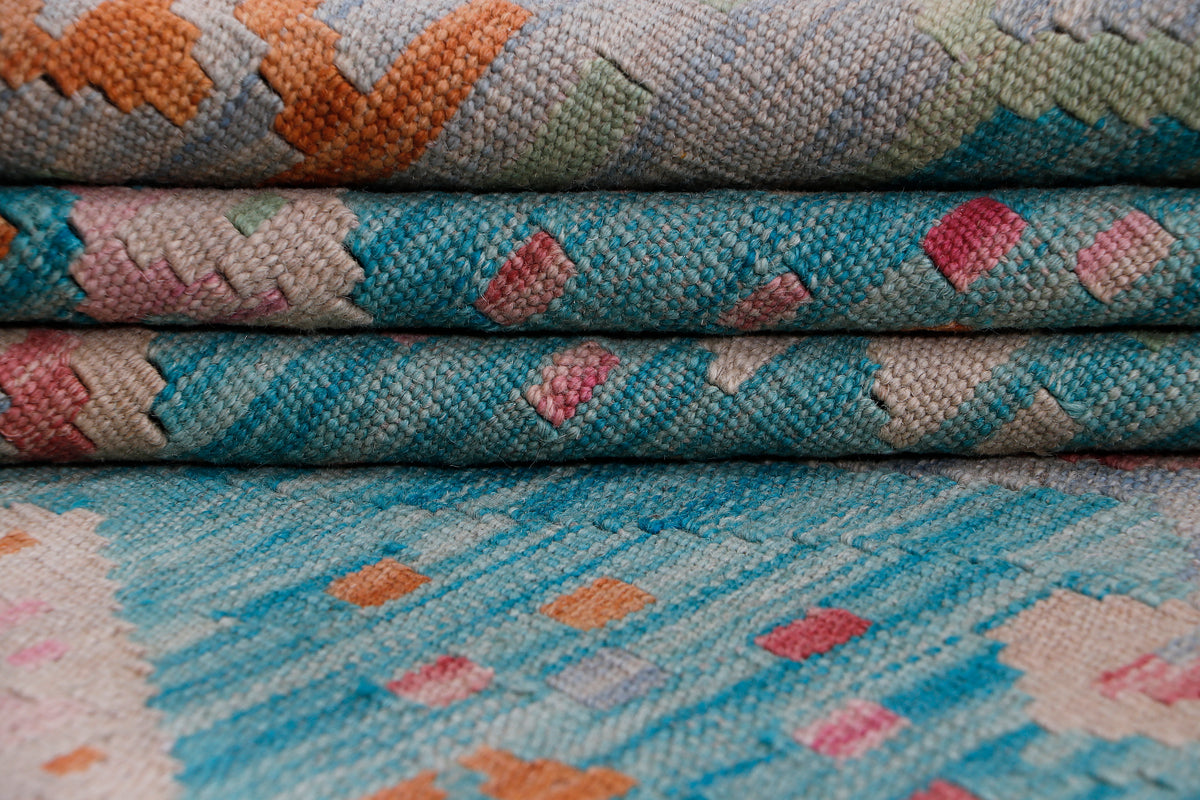 Blue kilim rug weaving close-up with orange and pink diamond motifs