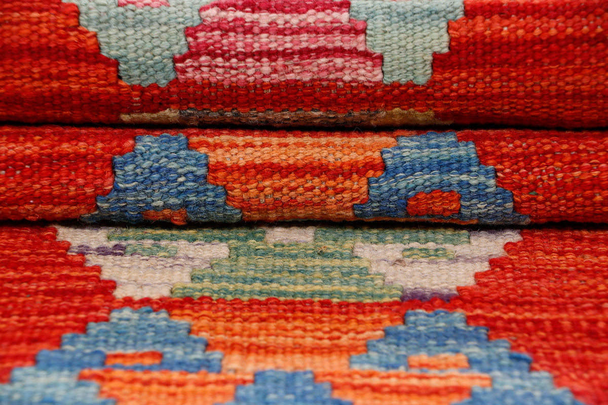 Kilim runner rug detail with red ground and blue-orange geometric shapes