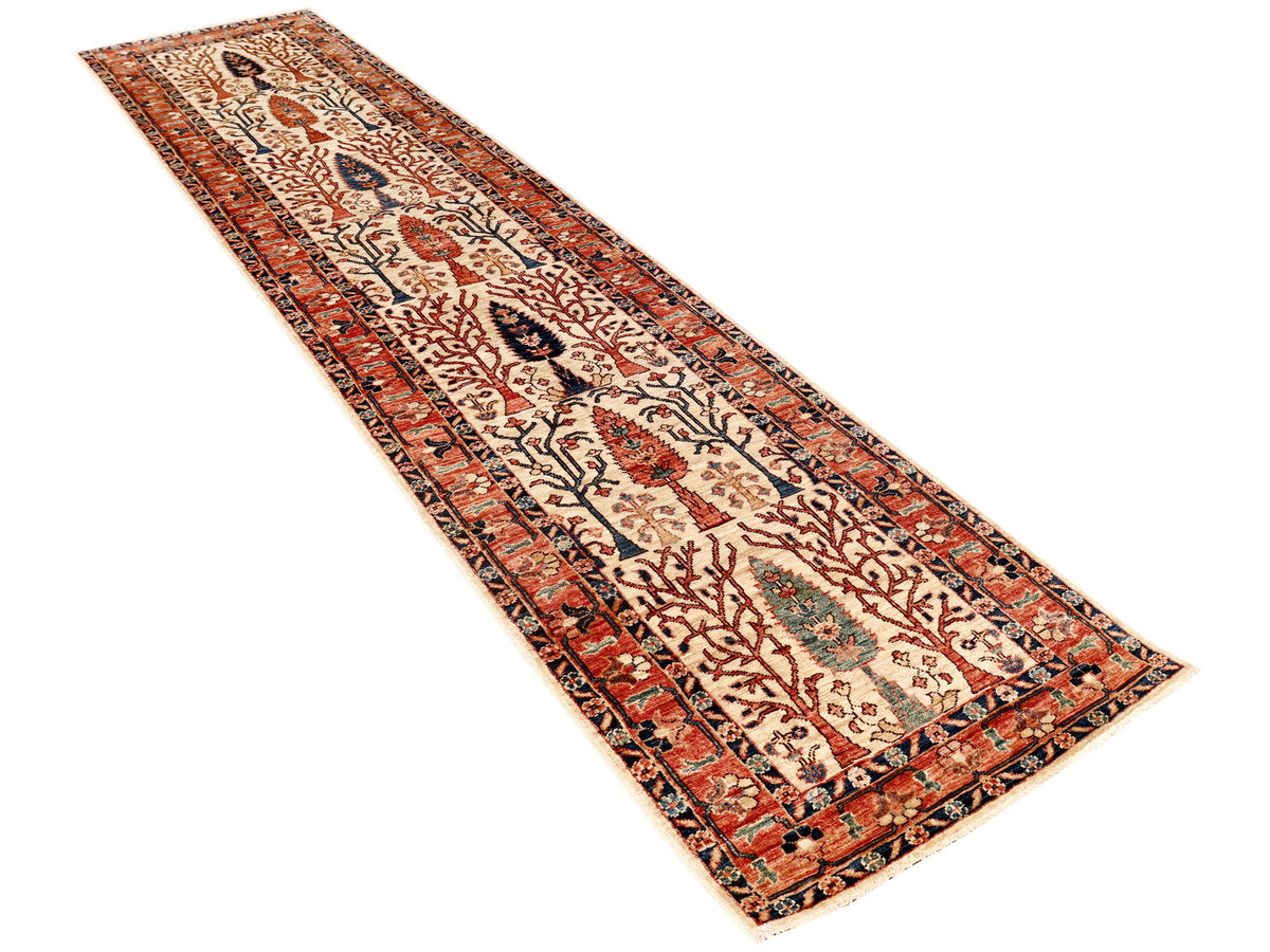 Slanted view of red, beige and dark blue patterned runner rug with border trim