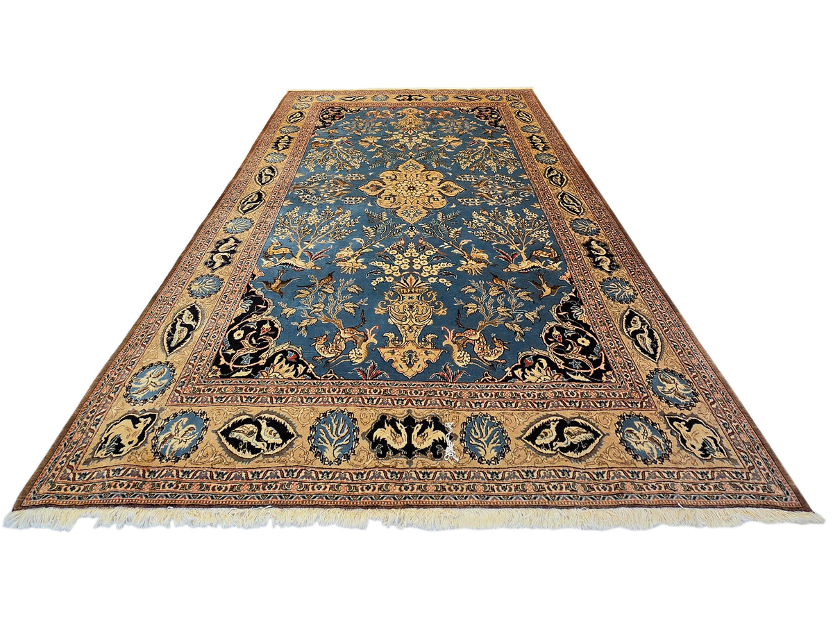 Blue patterned area rug with ornate border and white fringe ends