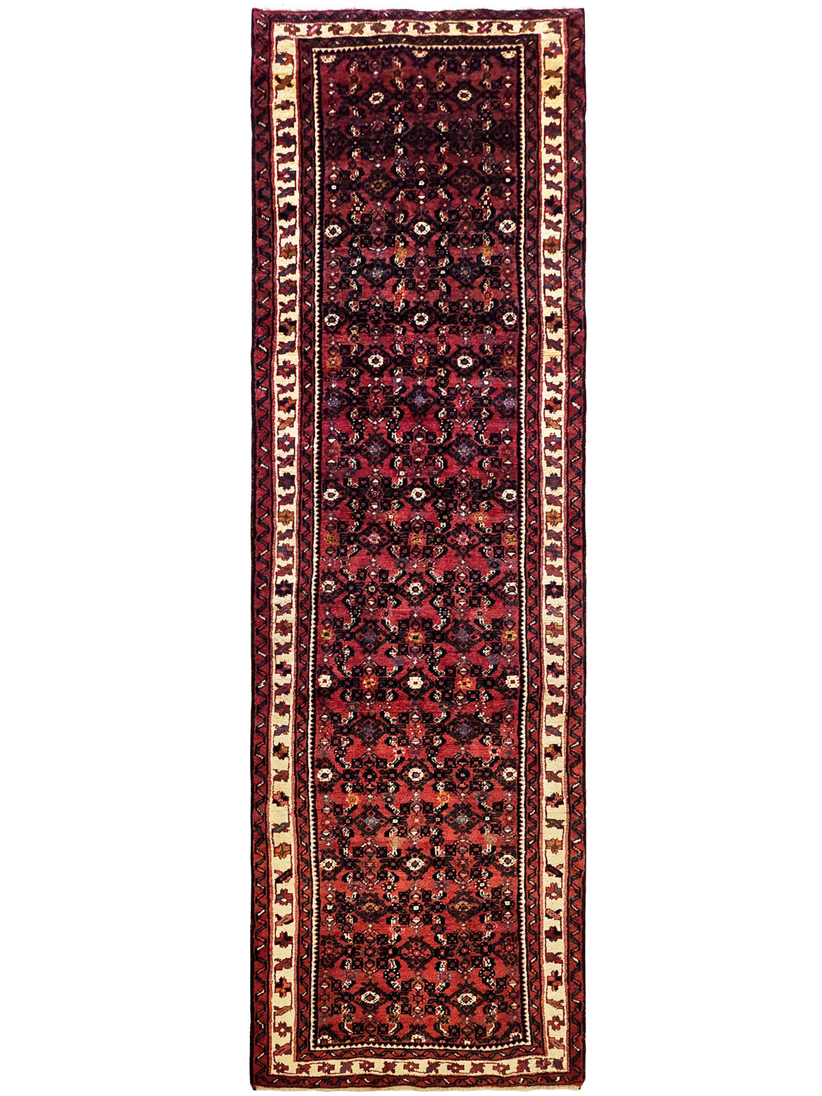 Burgundy runner rug with vertical panel of navy and cream floral motifs, fringed edges