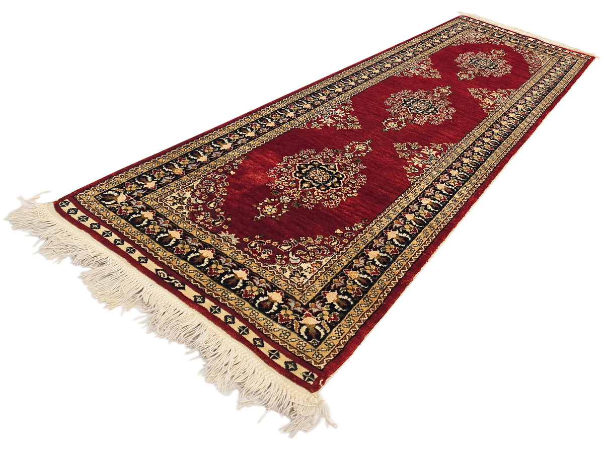 Hereke rug with deep red field, detailed floral motifs, and short beige fringe