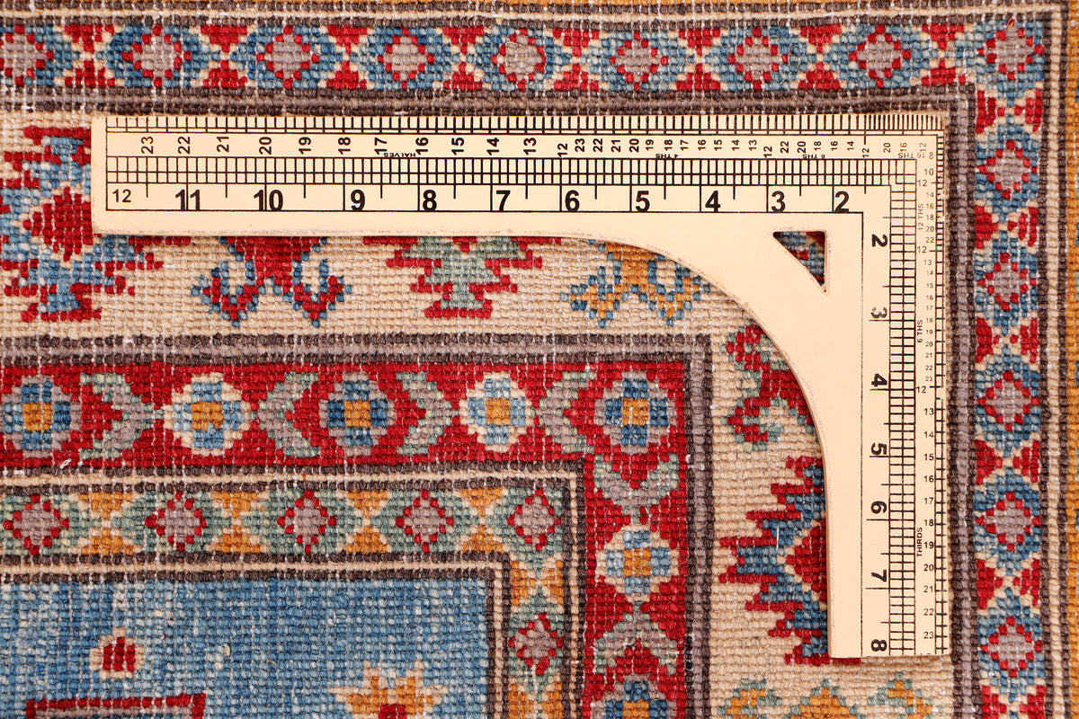 Blue patterned area rug with multicolor geometric border