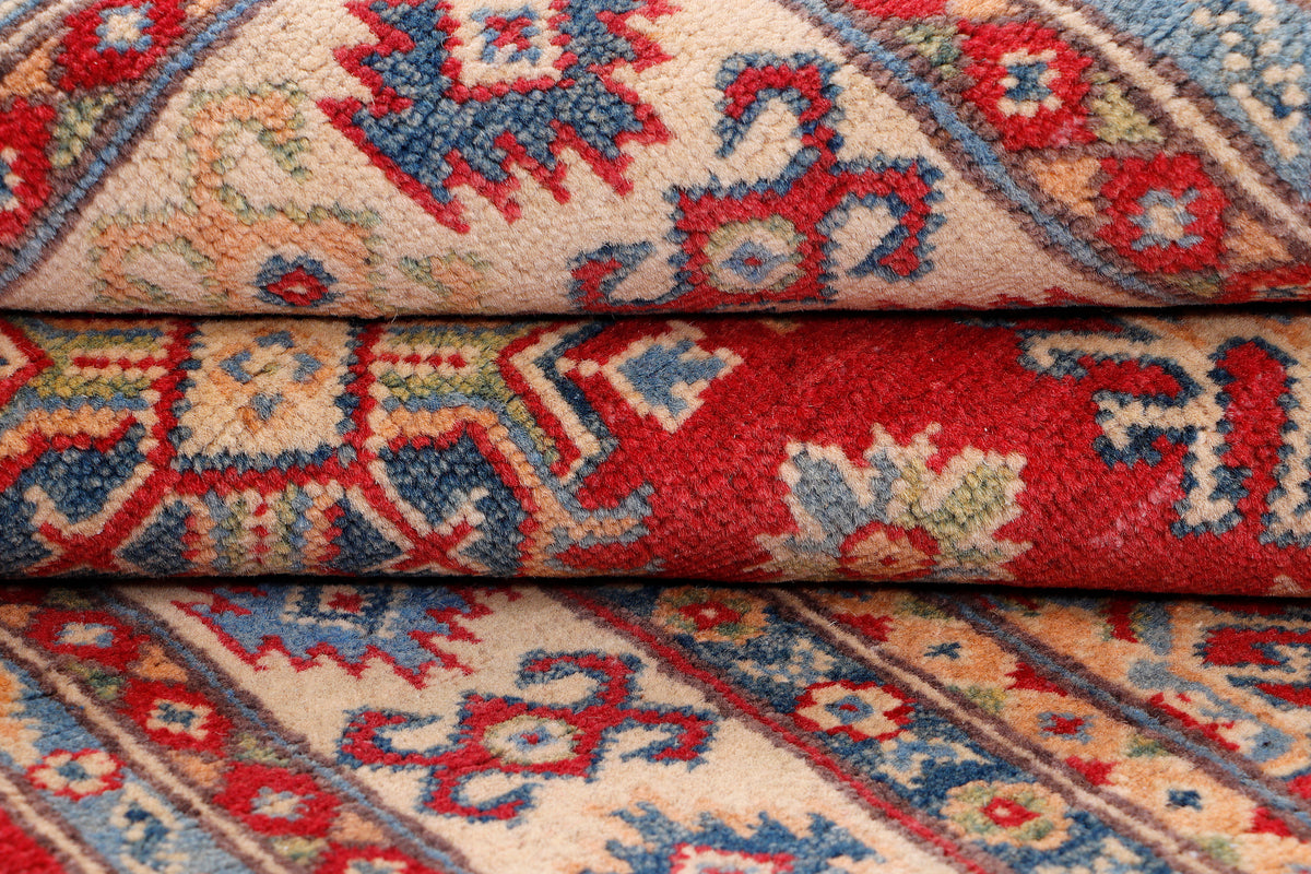 Red, blue, and cream rug with diamond and floral geometric pattern
