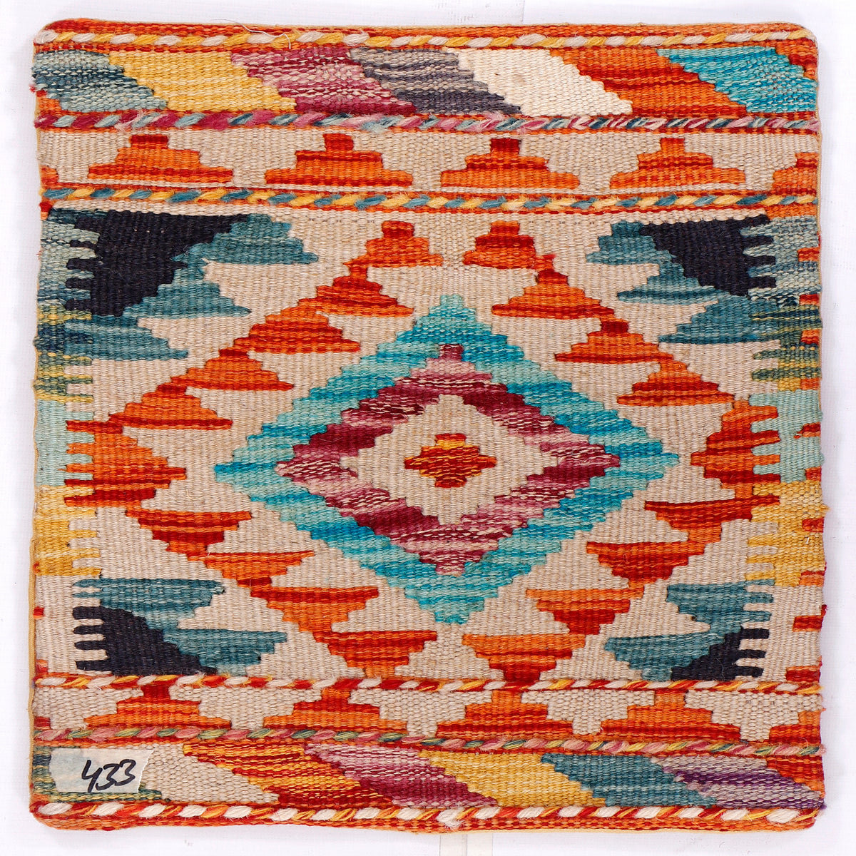 Geometric kilim cushion cover with orange, blue, and pink diamond motif
