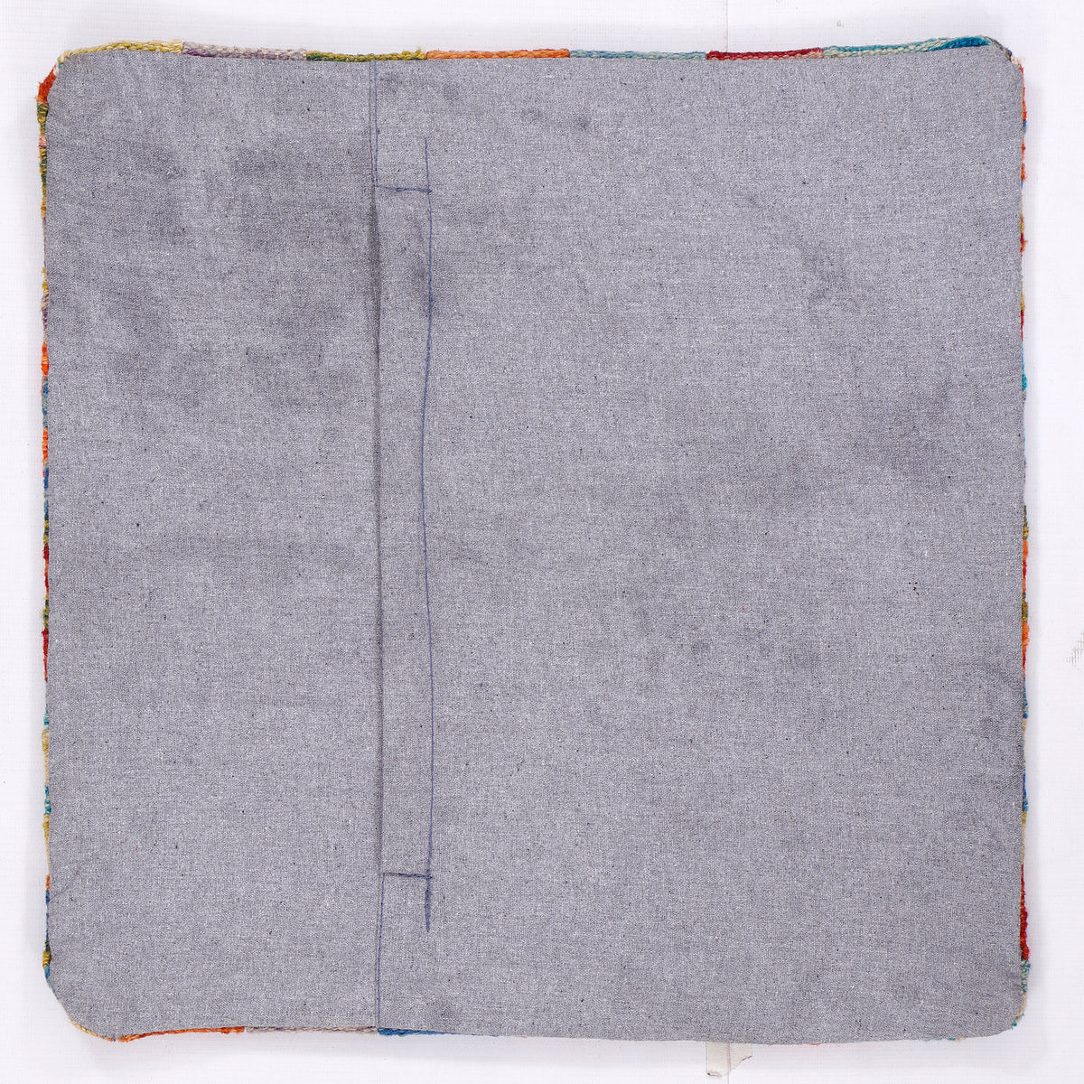 Square kilim cushion back in light gray fabric with central seam and zipper