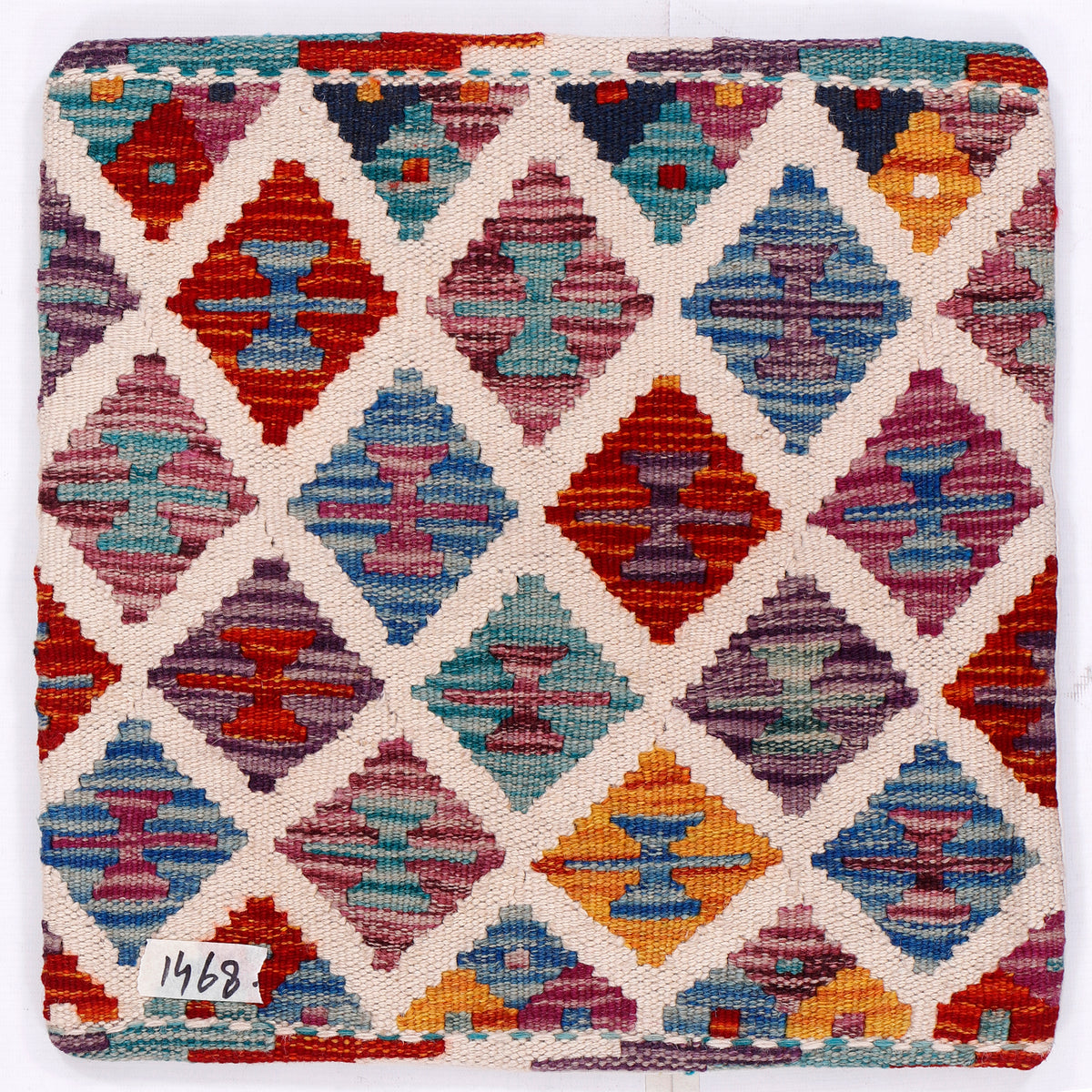 Multicolor diamond geometric kilim cushion front with woven texture on off-white ground