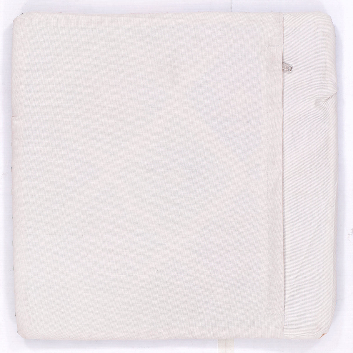Cream kilim cushion back panel with subtle textured weave and seam