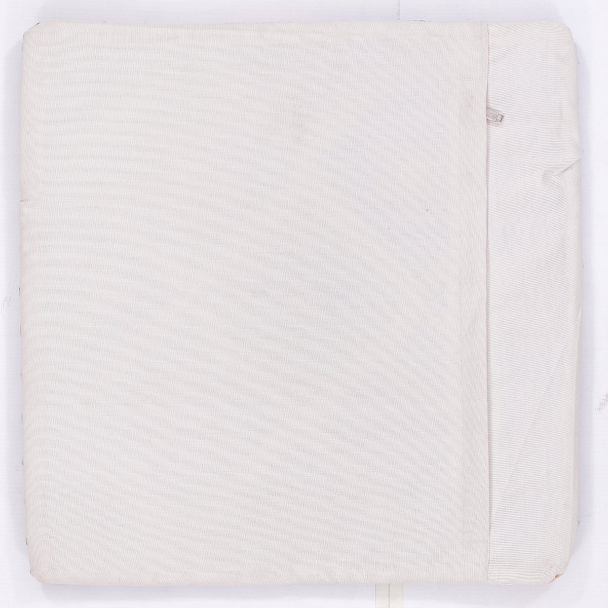 White kilim cushion cover back with subtle woven texture and stitched seam