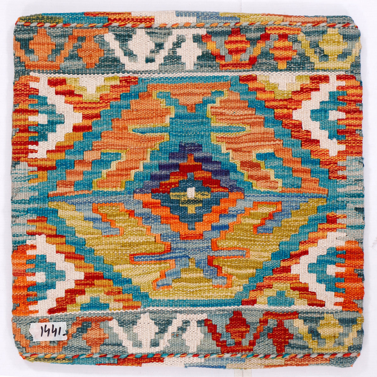 Kilim cushion cover close-up with teal-blue, orange, yellow medallion diamond pattern