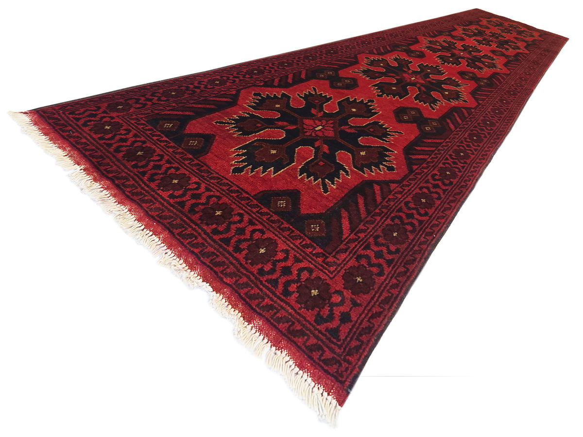 Maroon 290x79 rug with dark geometric medallions and cream fringe along edges