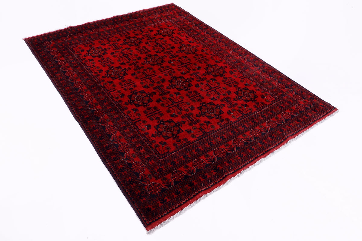 Rectangular red area rug with dark geometric motifs and flat woven texture