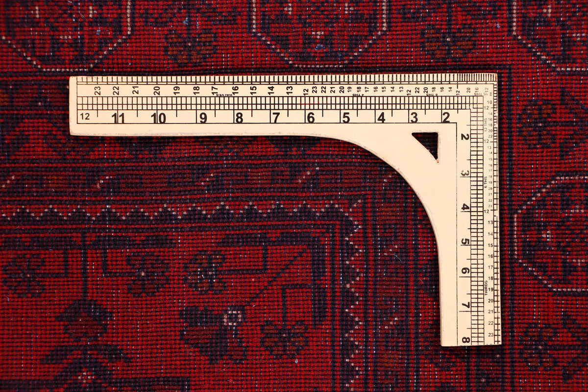 Red patterned area rug with border, taped dimensions 228x173 cm