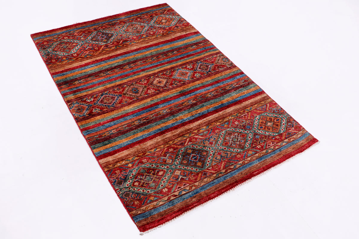 Red multicolor wool rug with geometric borders, angled full view