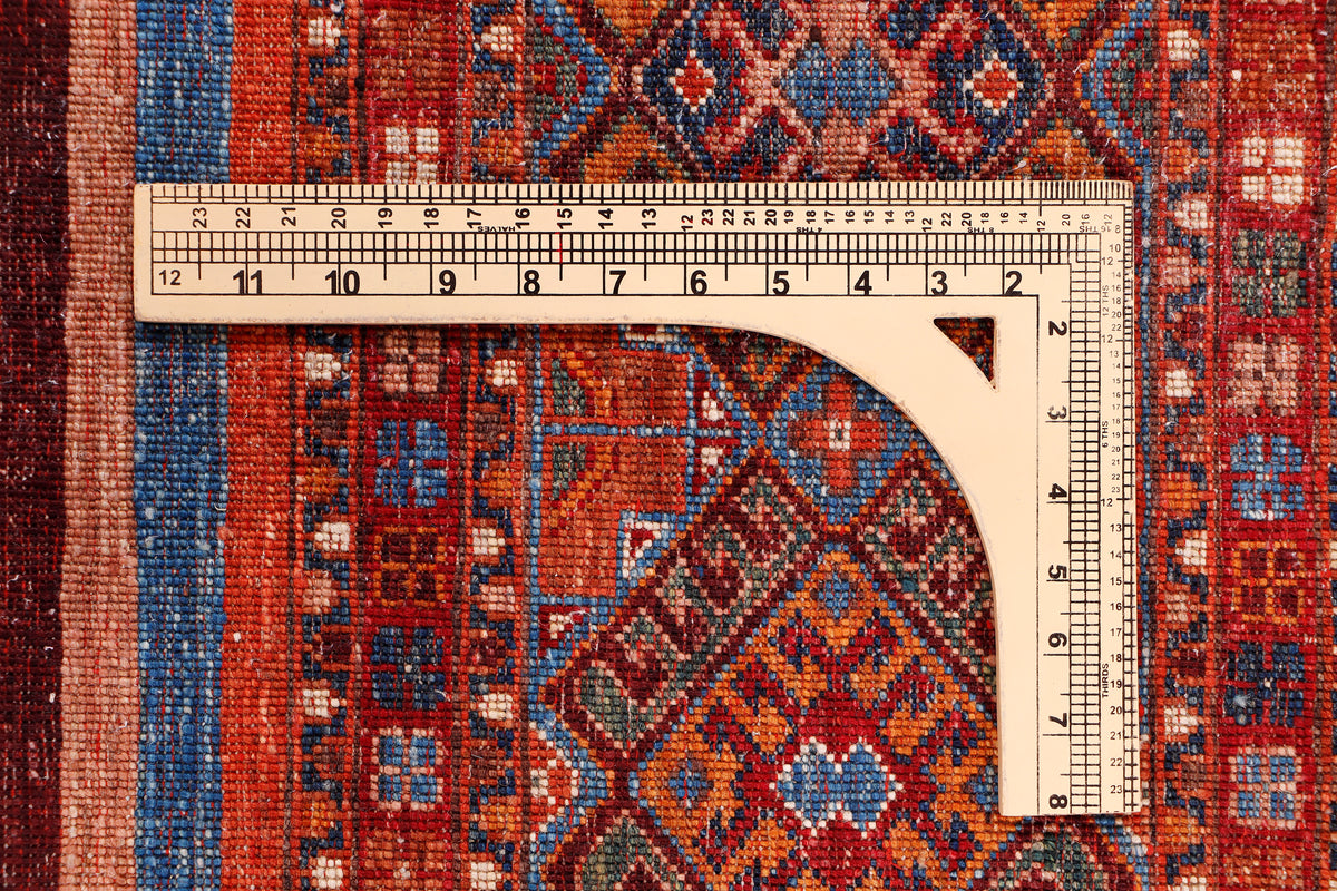 Red rug measured with a tape measure over the patterned center area