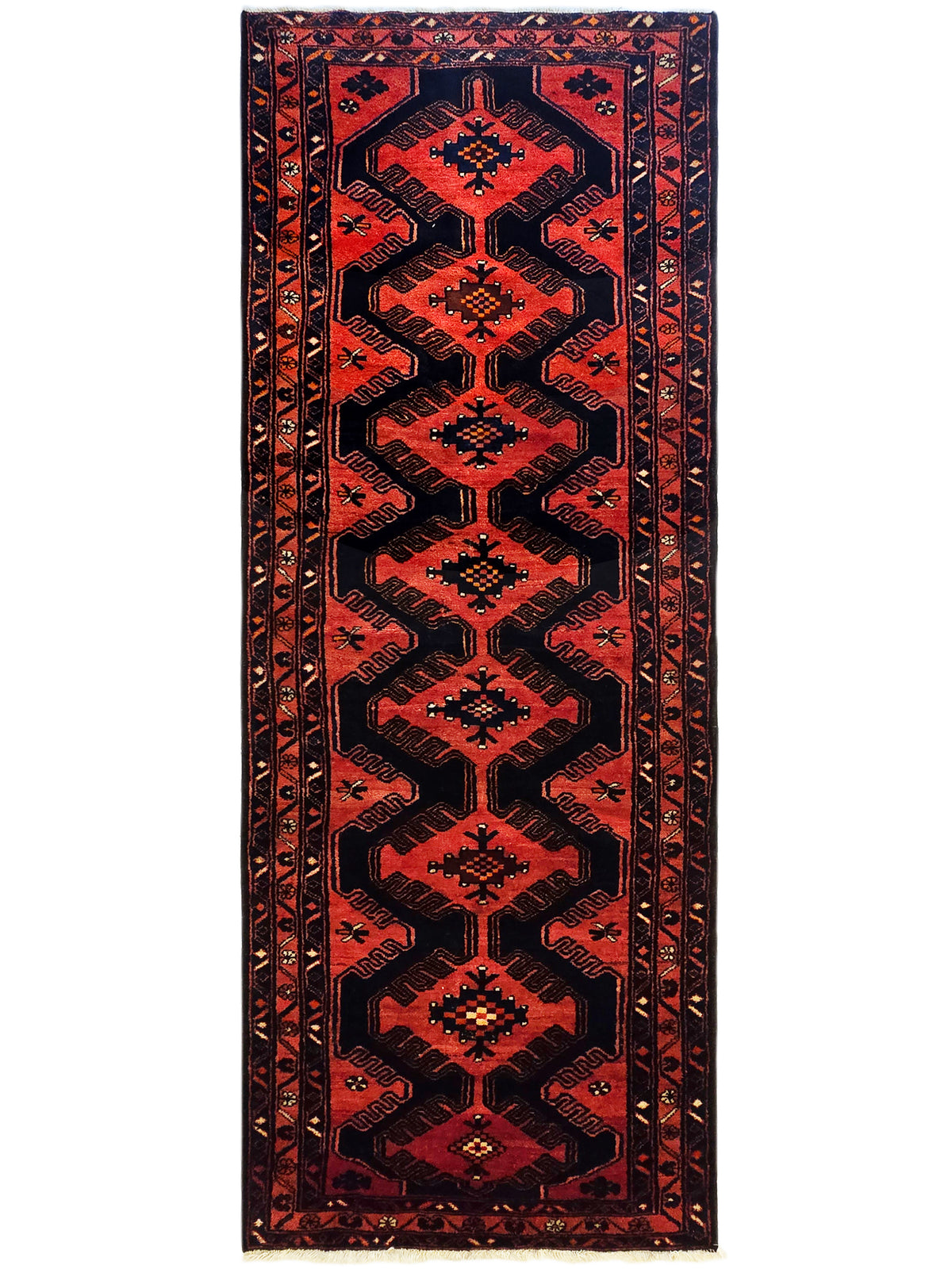 Red and black geometric patterned rug with central medallion and repeating border motifs.