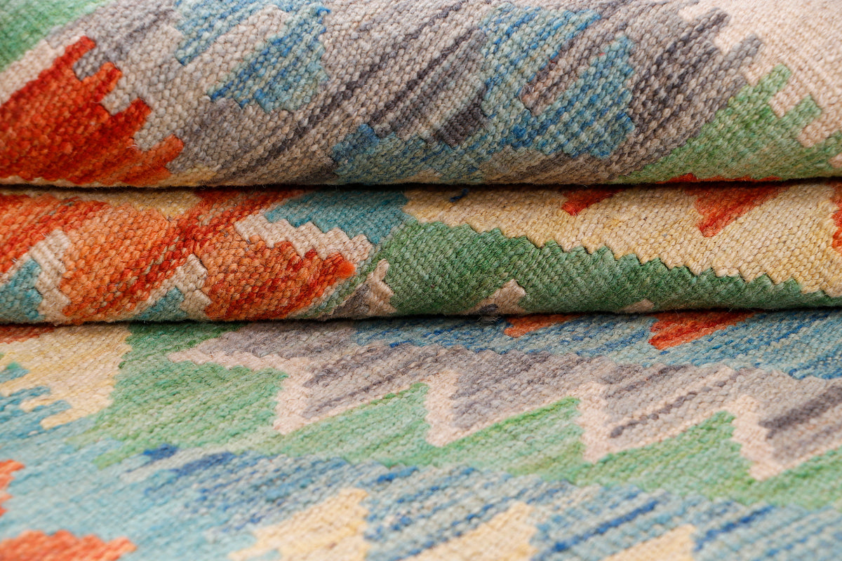 Rolled edge of multicolor flatweave rug showing woven texture and short fringe