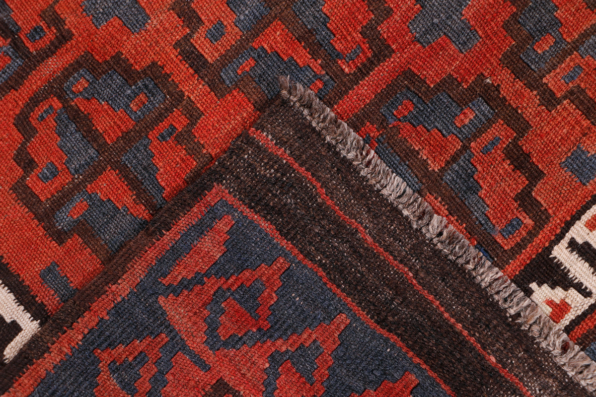 Kilim rug corner detail with red and dark blue geometric border