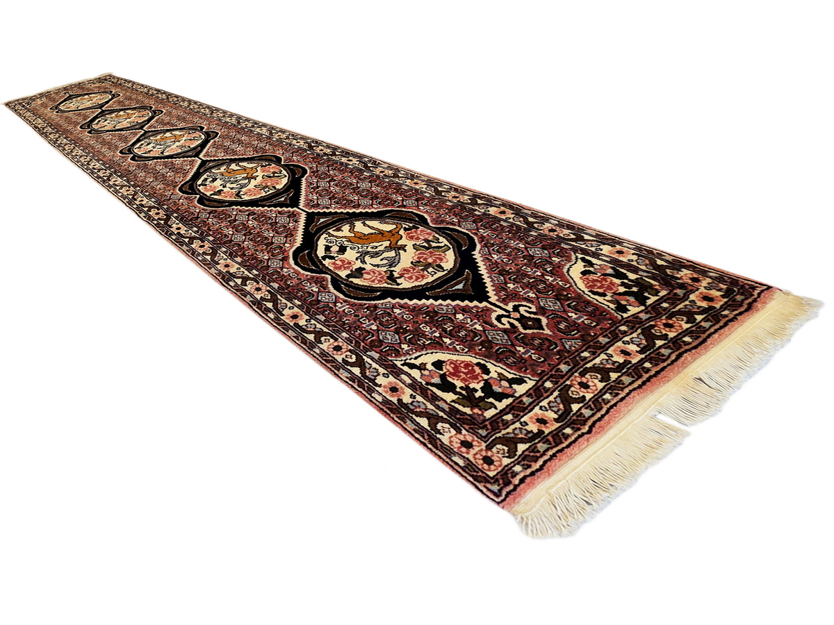 Runner rug with maroon, cream, and black geometric motifs and short fringe trim