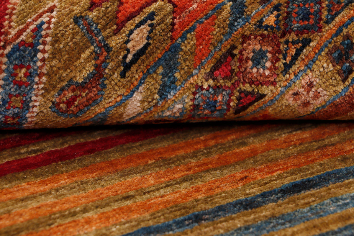 Geometric rug texture close-up with blue, tan, red and orange stripe patterns