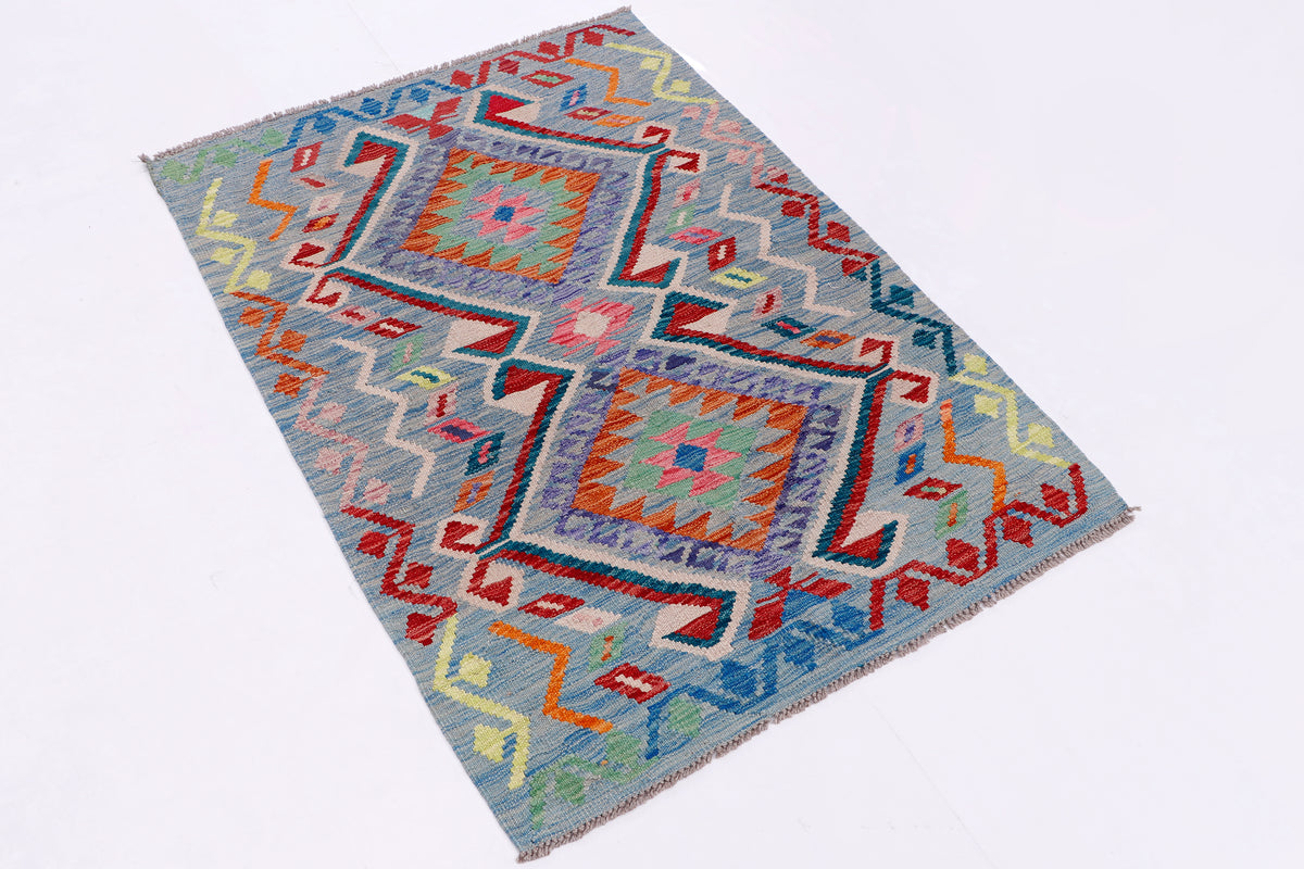 Rectangular kilim rug with multicolor geometric squares and border on blue background