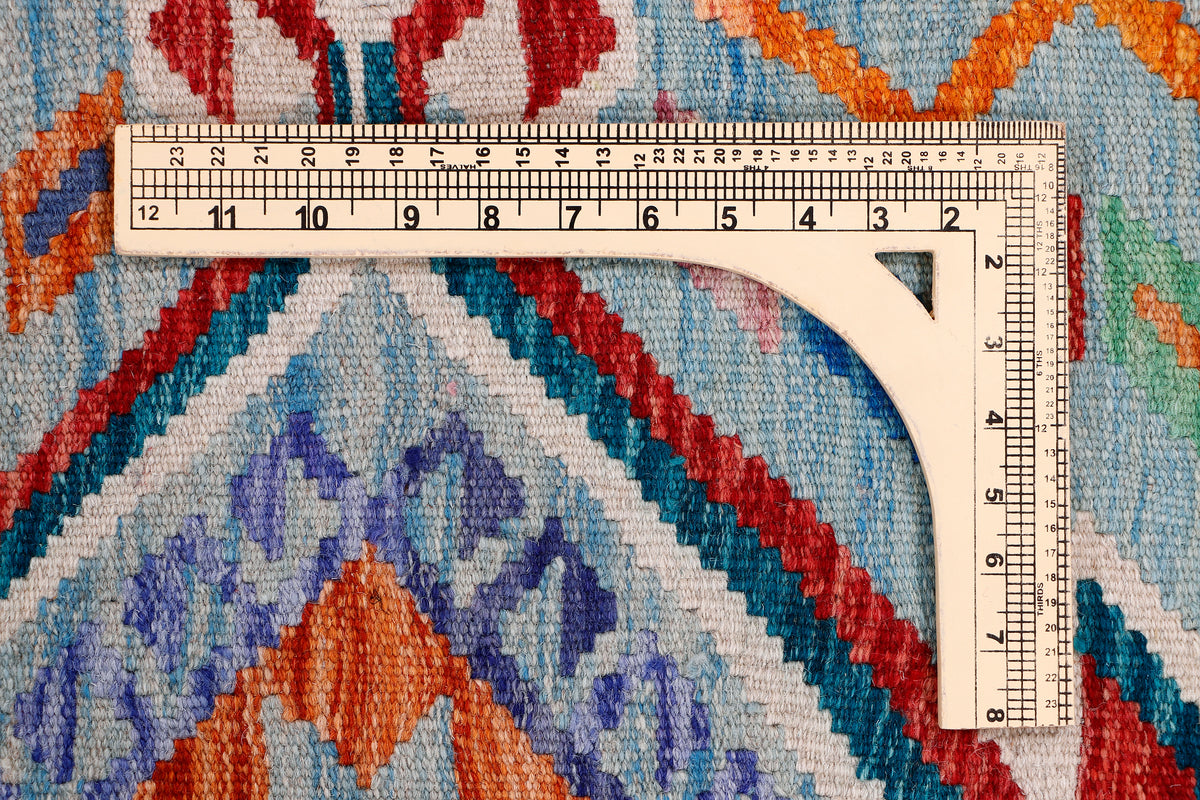 Kilim rug with arched medallion design; blue field with red and orange geometric stripes