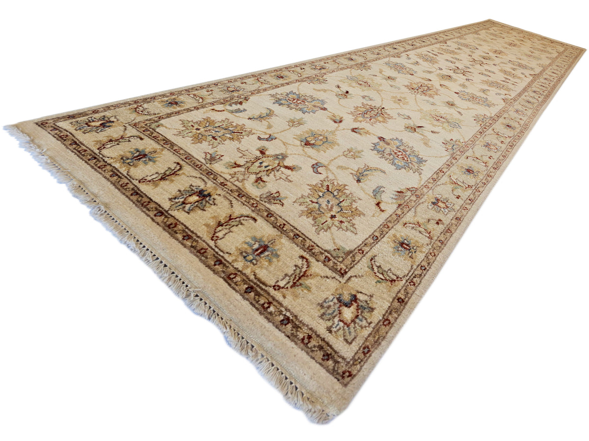 Beige floral decorative runner rug with dark border and fringed corners