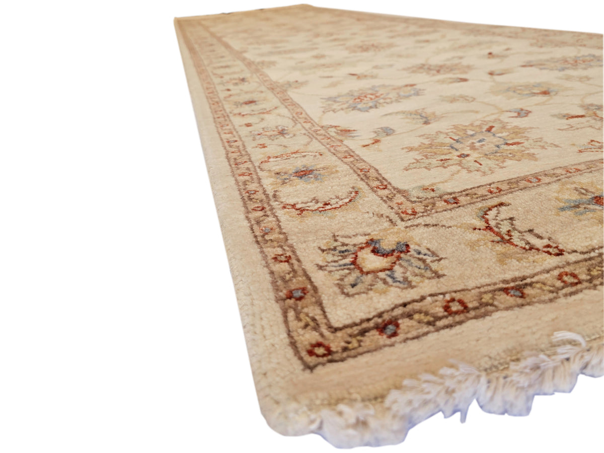 Beige floral runner rug with red-brown accents and tassel fringe edge