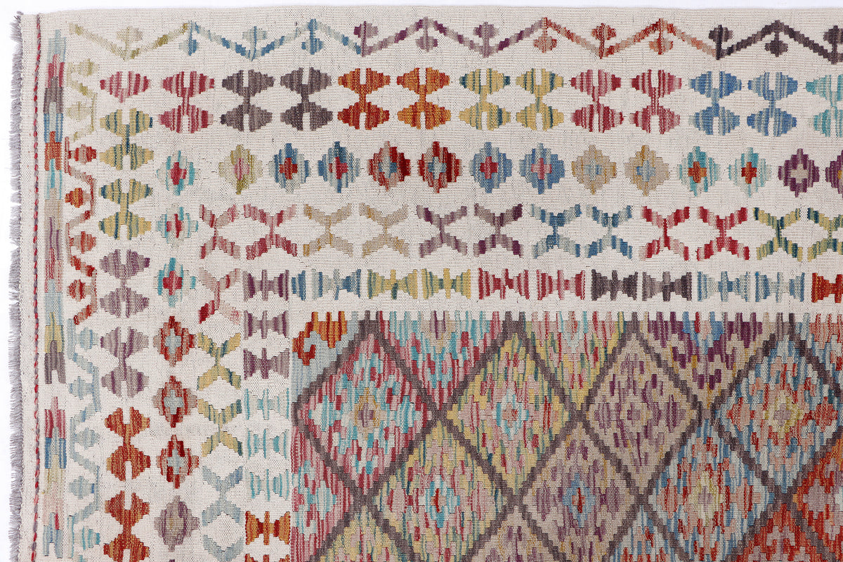 Beige kilim diamond rug close-up of repeating multicolor geometric motifs