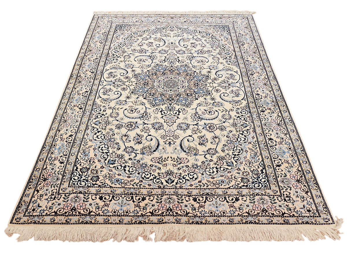 Large rectangular cream rug with blue medallion, detailed border and short fringe