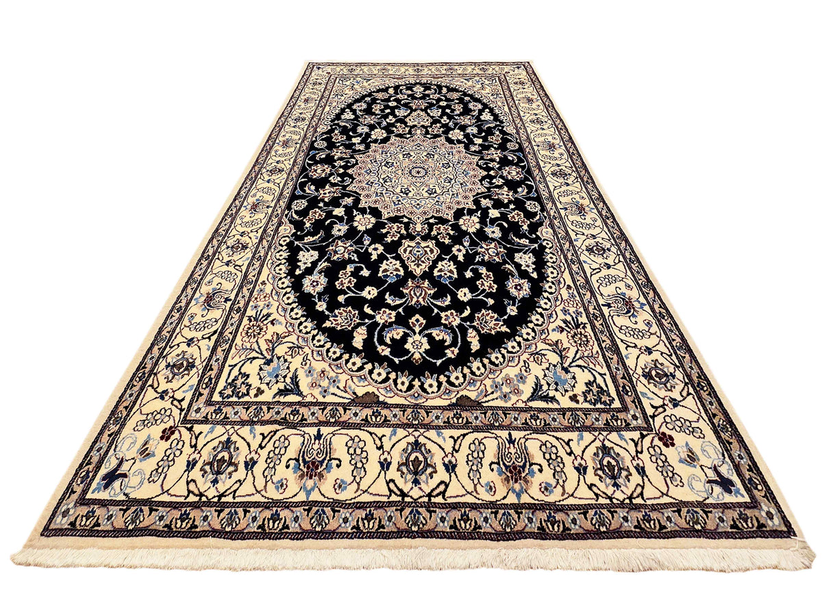 Nain rug flat view with black medallion, cream field, and ornate border
