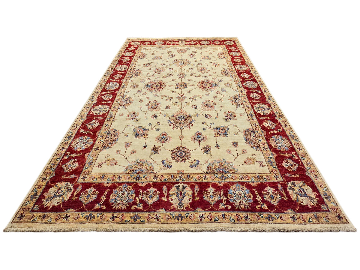Traditional rug full view with cream center, red border stripes, and floral sprays