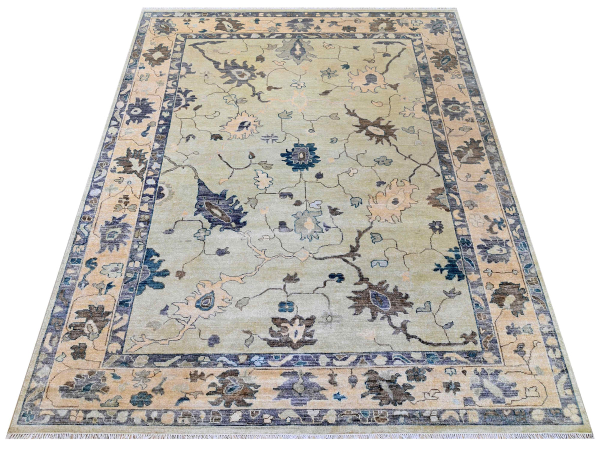 Oushak rug with light beige background, blue and muted brown floral vine pattern