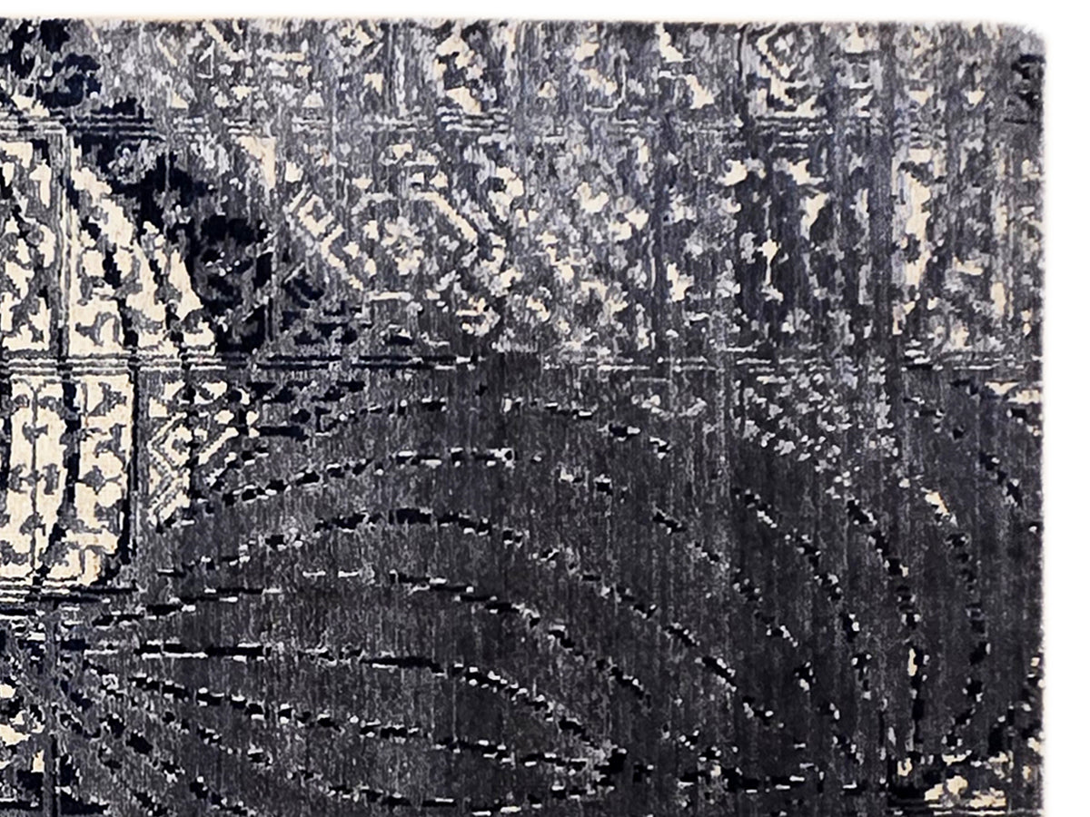 Dark navy and beige rug with distressed layered texture and stitched linework