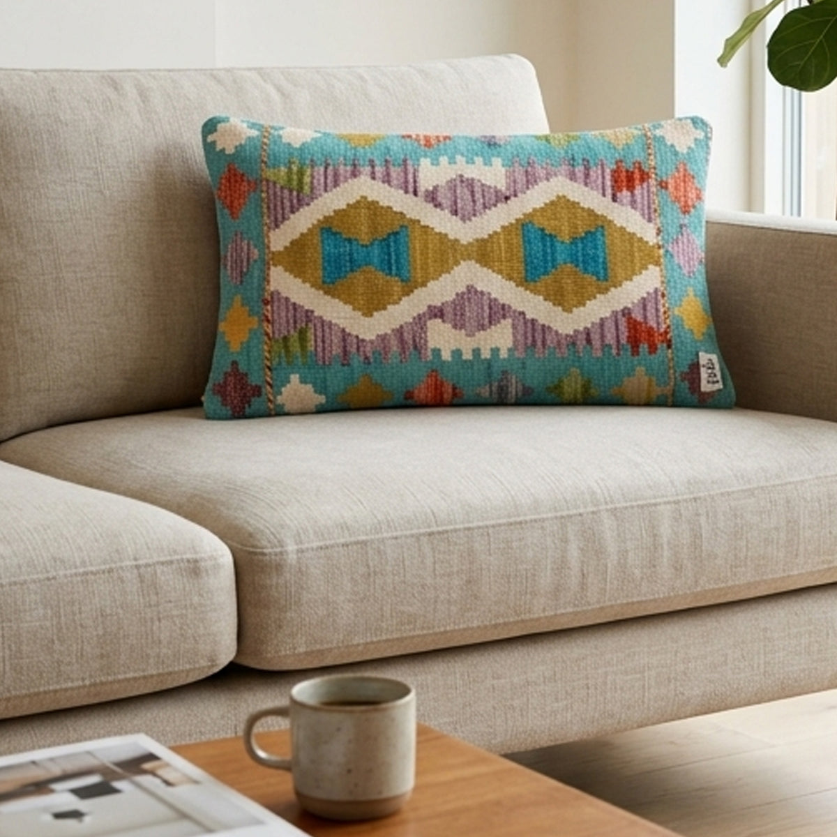 Kilim cushion cover on sofa with wavy geometric diamonds in turquoise and gold, 35x55 cm