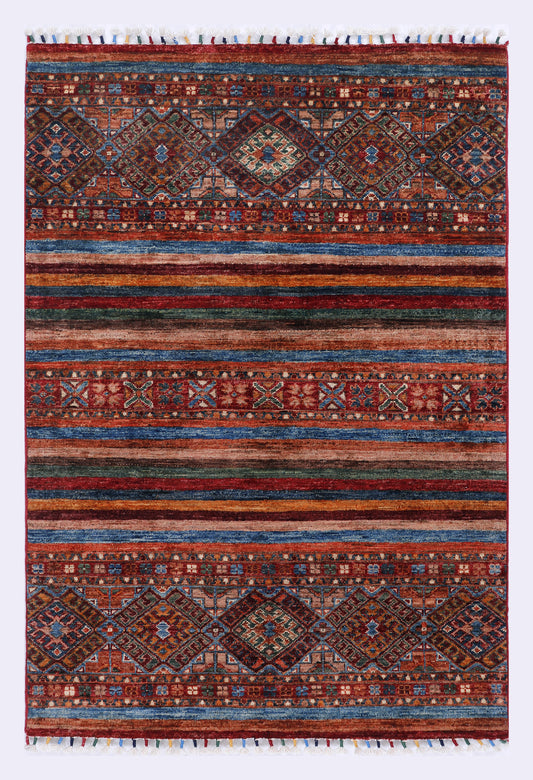 Red and navy patterned rug with geometric motifs and fringe edges, rectangular