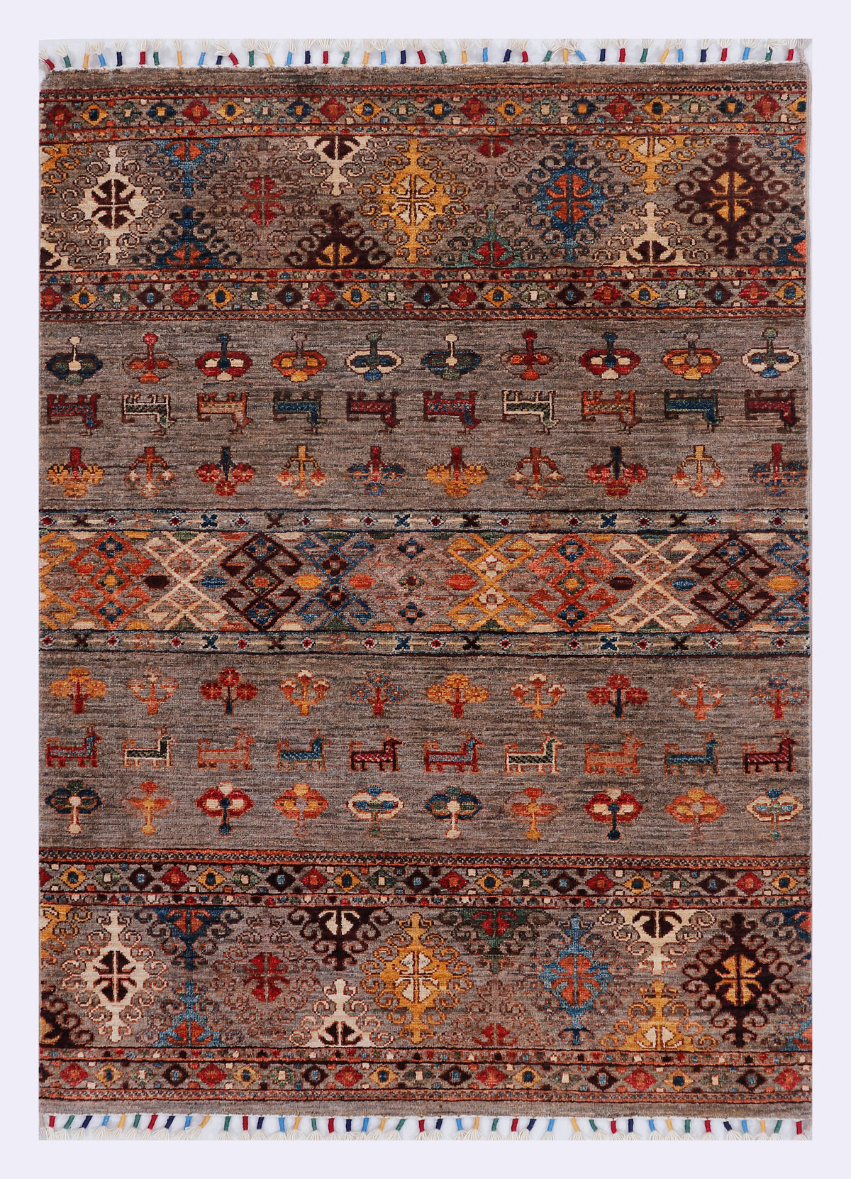 Grey rug with wide patterned bands featuring star and cross motifs in orange and blue.