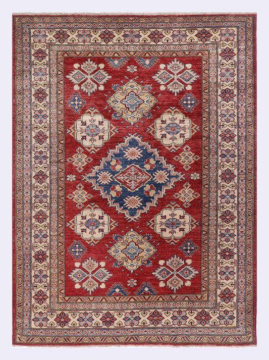 Red Kazak rug with central medallion and geometric floral pattern, decorative border