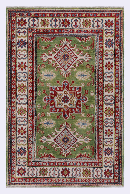 Green area rug with ornate central medallion and red-blue patterned border