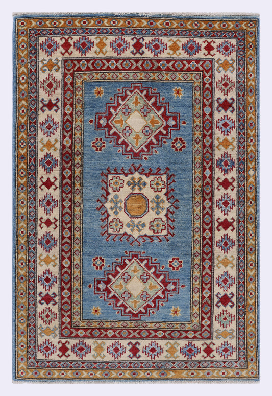 Blue rug 144x96 cm with ornate geometric border and multicolor center medallion.