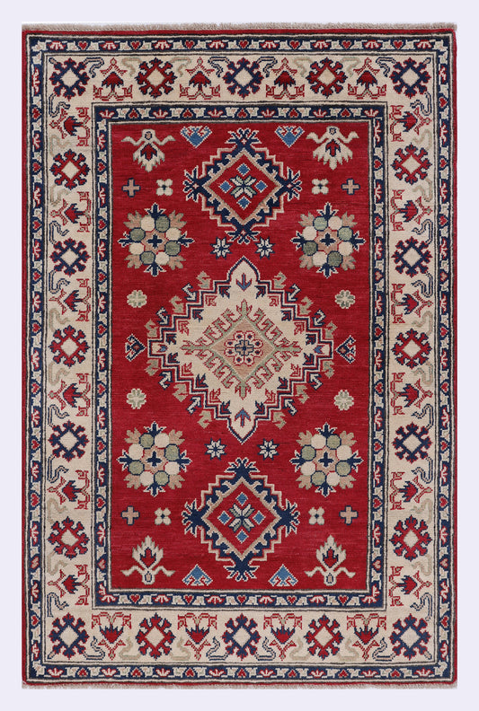 Kazak red rug with multicolor geometric border and center medallion, 152x99 cm