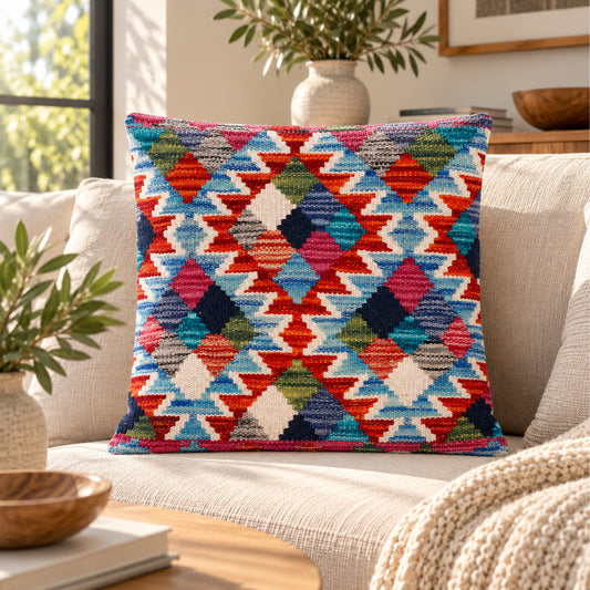 Square zigzag kilim cushion on sofa, blue base with red, orange, green, and cream pattern