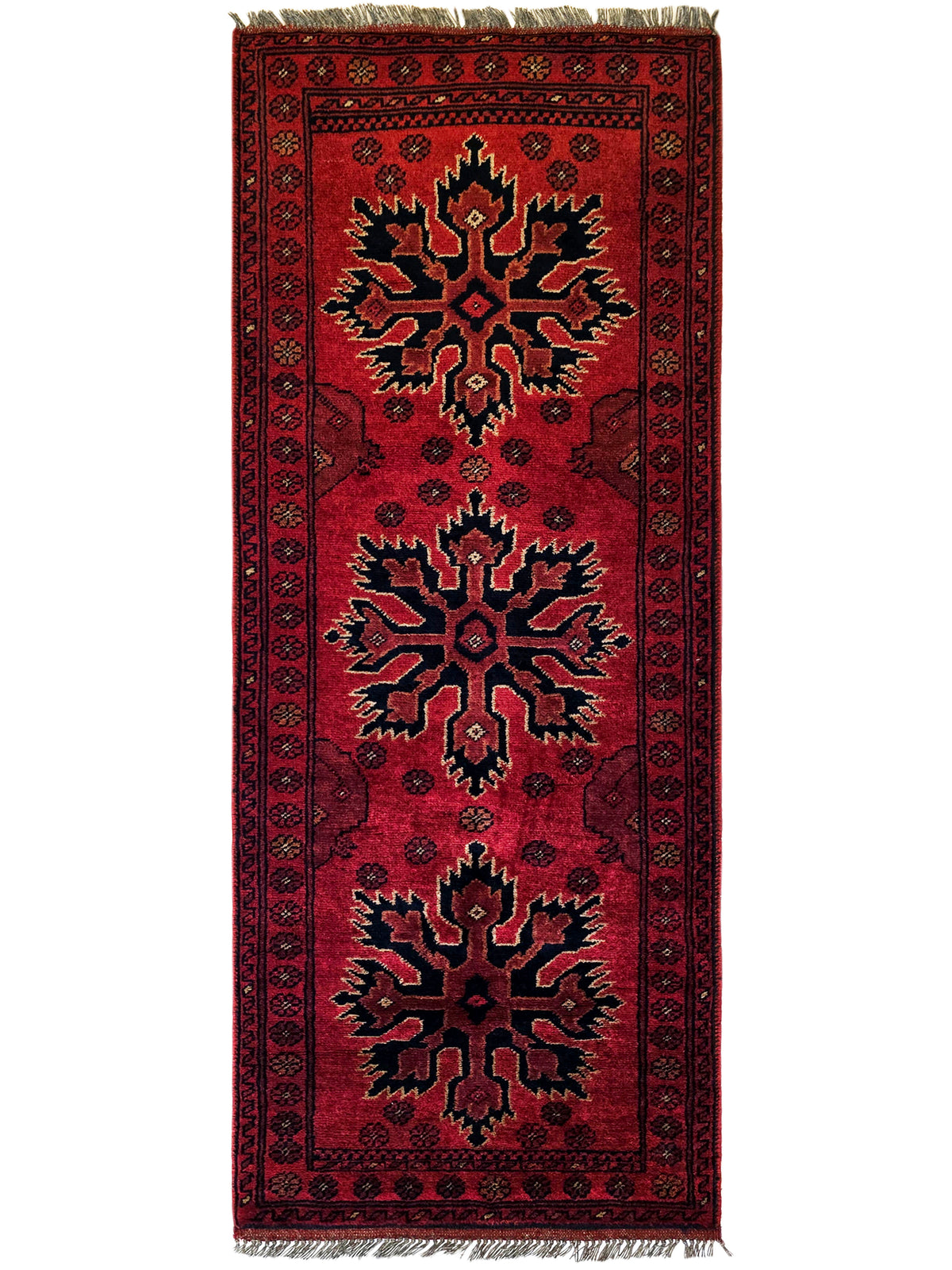 Red Afghan rug with vertical layout, repeating corner motifs, dark border, fringed top.