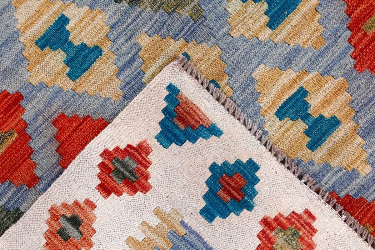 Kilim rug corner detail with fringe and multicolor diamond motifs