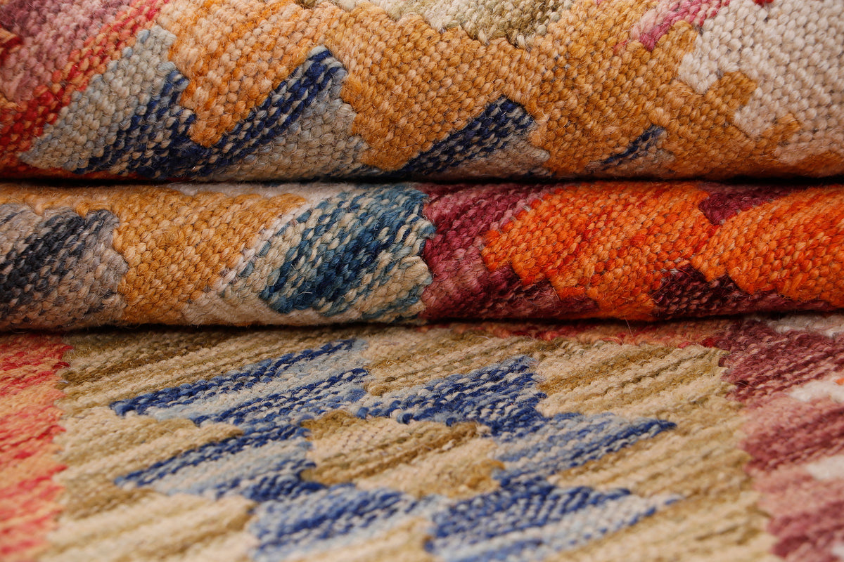Kilim rug weave texture close-up with multicolor geometric pattern on beige