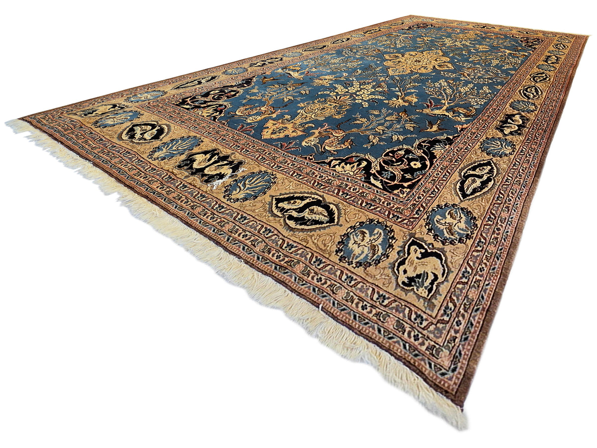 Blue and brown patterned rug with short white fringe along one edge