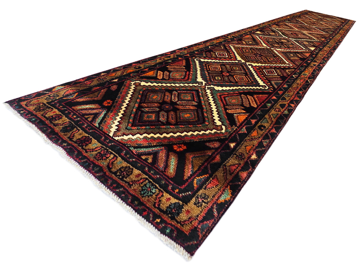 Hamedan rug runner corner view with tribal geometric medallions in rust and teal