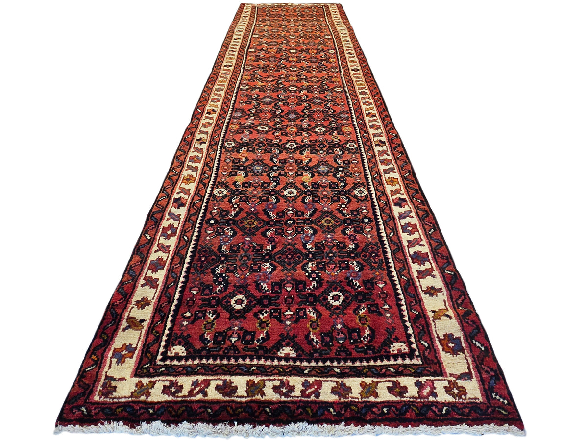 Burgundy runner rug with navy floral medallions, cream border stripes