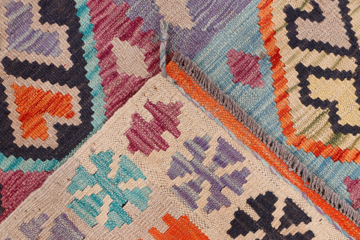 Kilim rug corner detail with multicolor geometric pattern and flatwoven texture