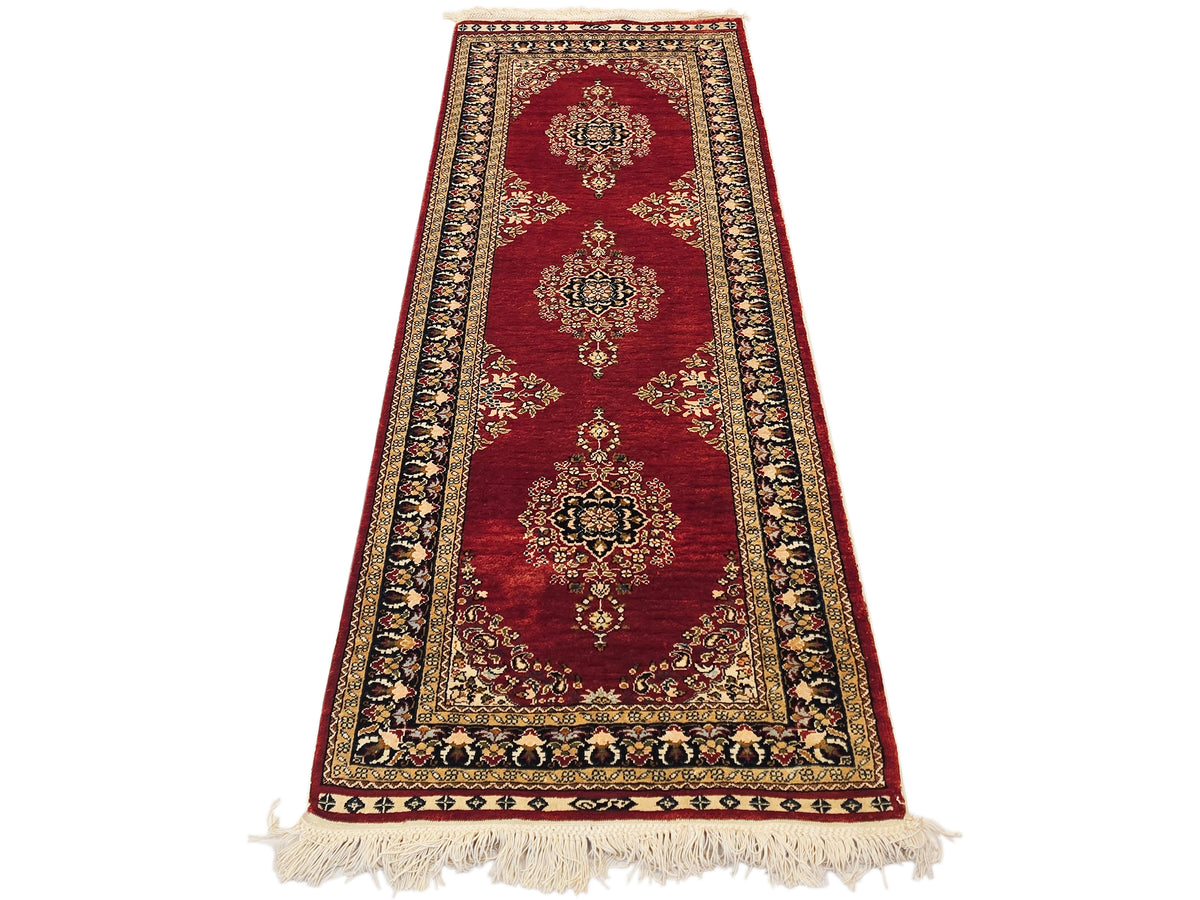 Hereke rug in deep red with ornate floral medallions and beige fringe edging